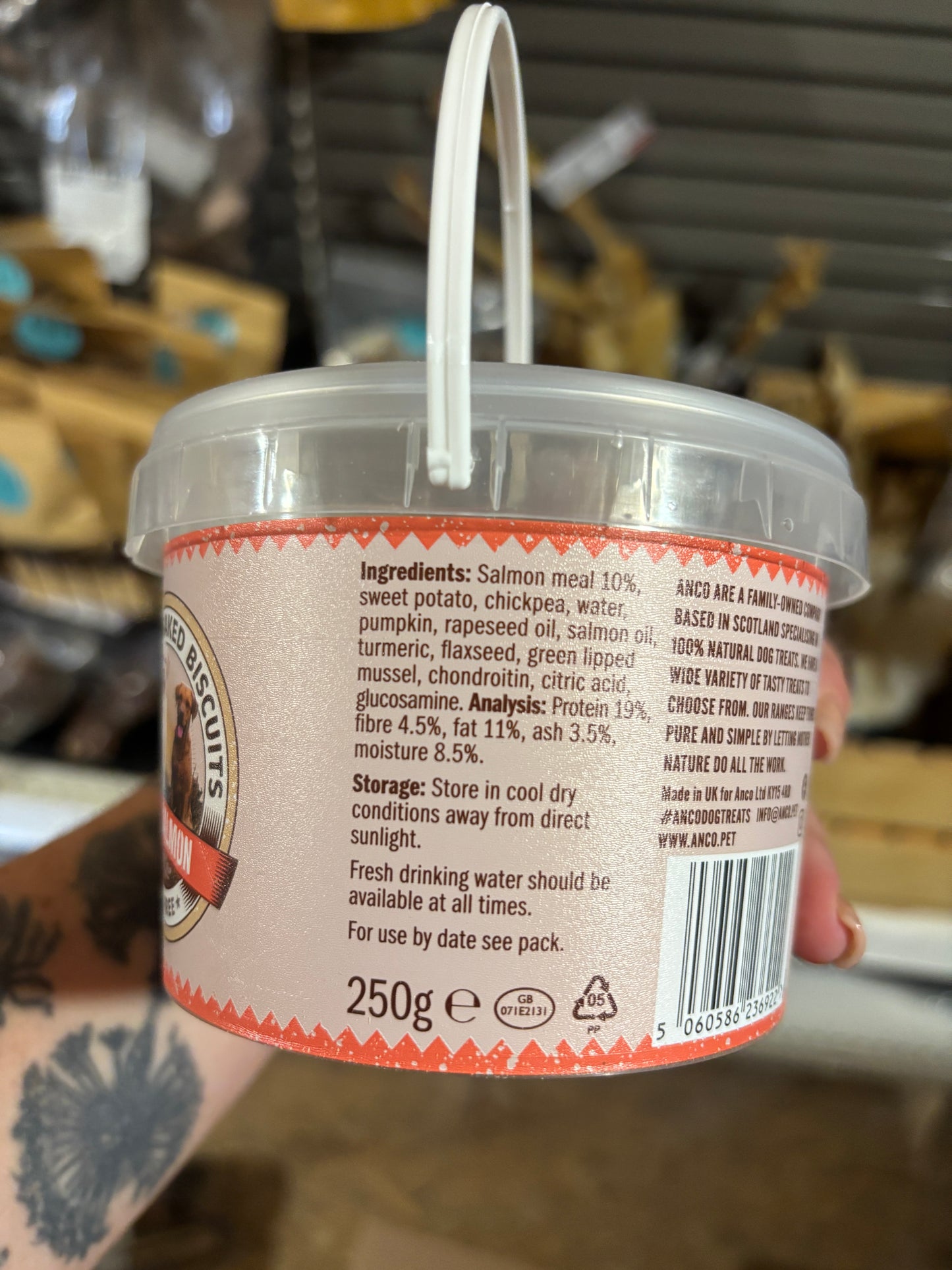 Container with a label held by a person, blurred background