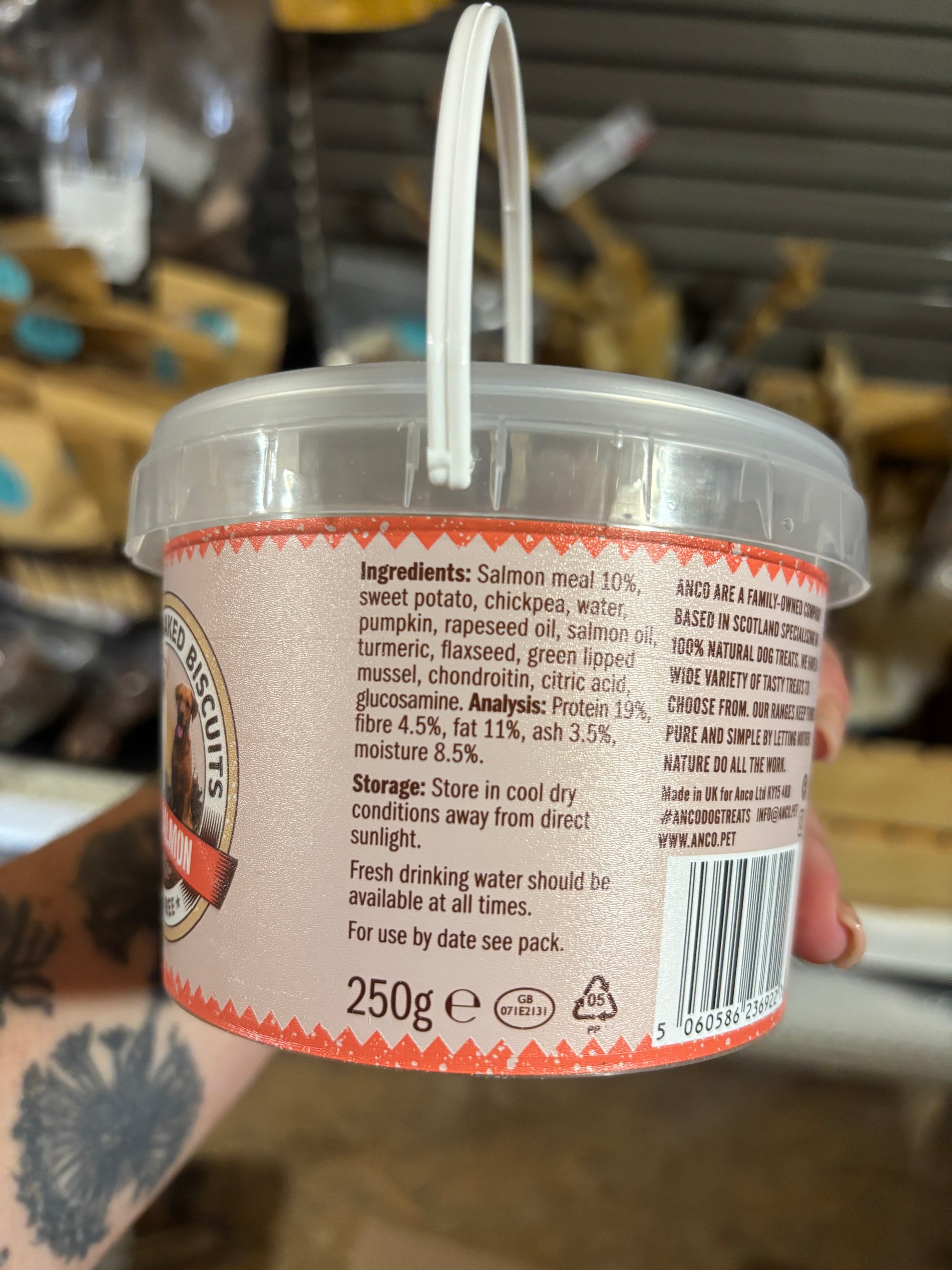 Container with a label held by a person, blurred background